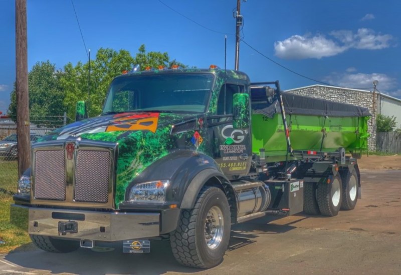 CG Environmental dump truck parked outdoors on a sunny day