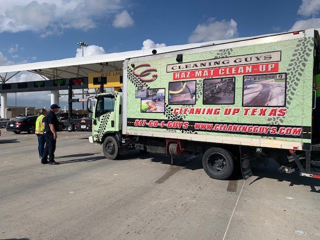 Cleaning Guys' hazmat cleanup truck at a highway toll area